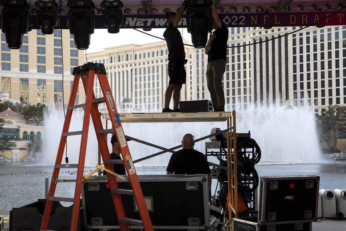 NFL Network crew members dismantle the NFL draft stage in the Bellagio Fountain on Saturday, Ap ...