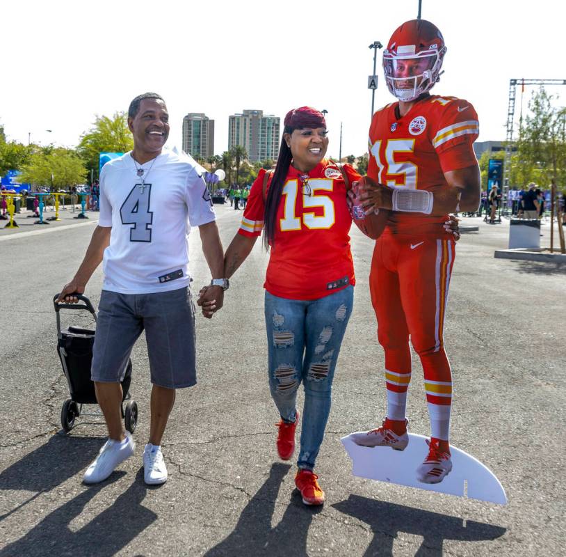 Charles and Delores Burton of Las Vegas walk with a Patrick Mahomes cutout through the Draft Ex ...