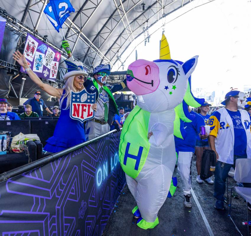 Seattle Seahawks fans dance as they announce their next pick in the Draft Theatre during the th ...