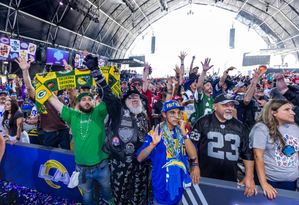 Fans cheer for their teams in the Draft Theatre during the third day selections for the 2022 NF ...