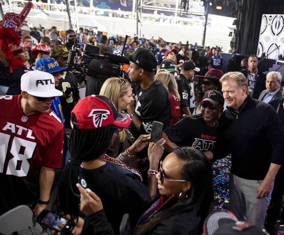 NFL commissioner Roger Goodell, right, socializes with fans during day three of the NFL draft o ...