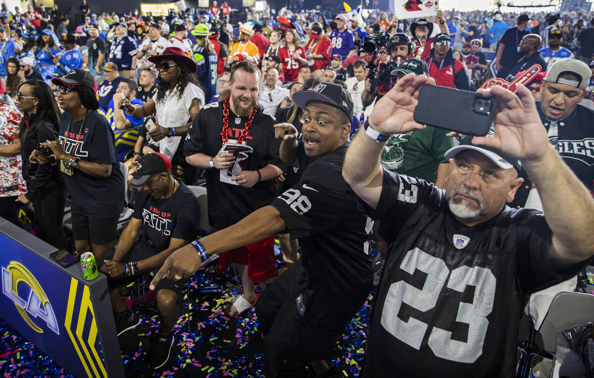 Raiders fans Darrin Tullis, middle, from Las Vegas, and Lucky Gonzalez, from Stockton, Calif., ...