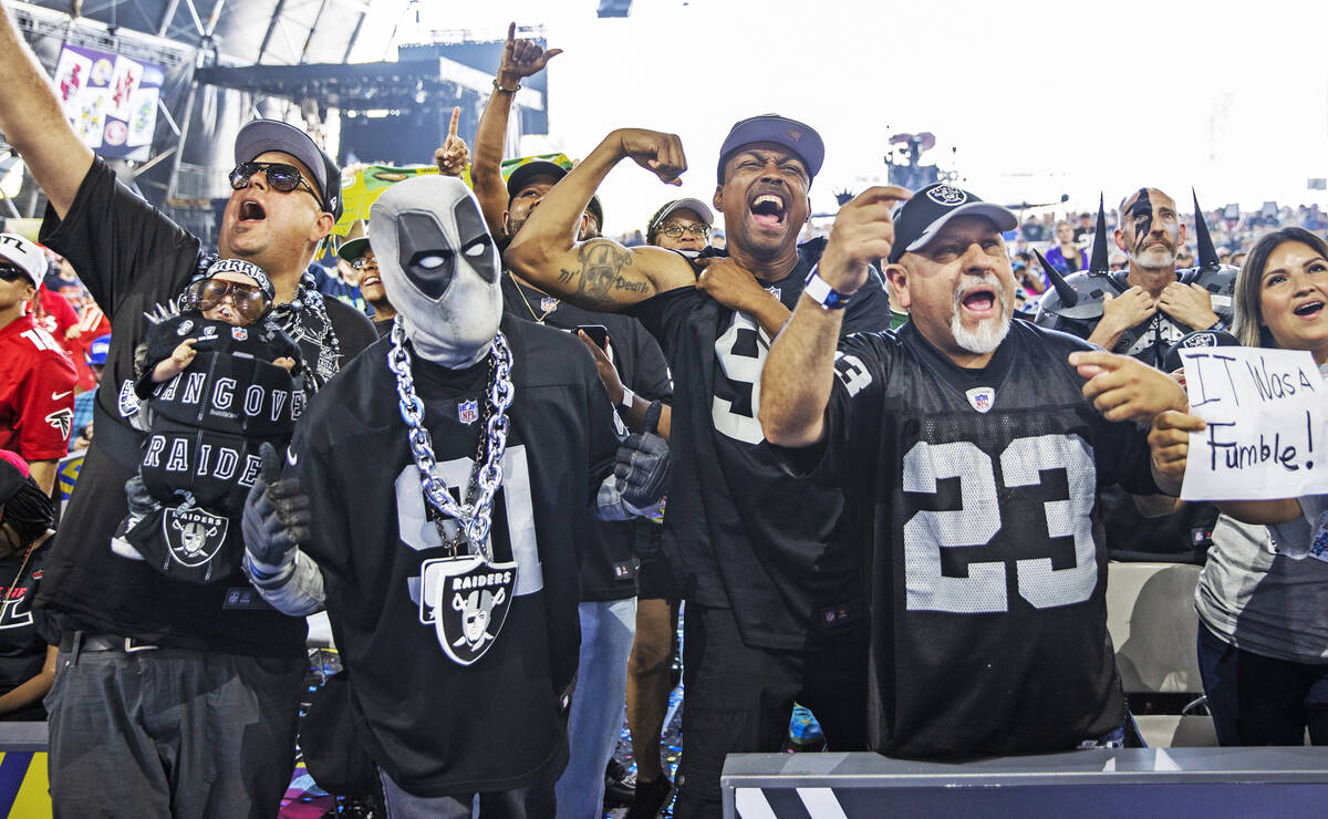 Raiders fans celebrate after Las Vegas made a draft pick during day three of the NFL draft on S ...