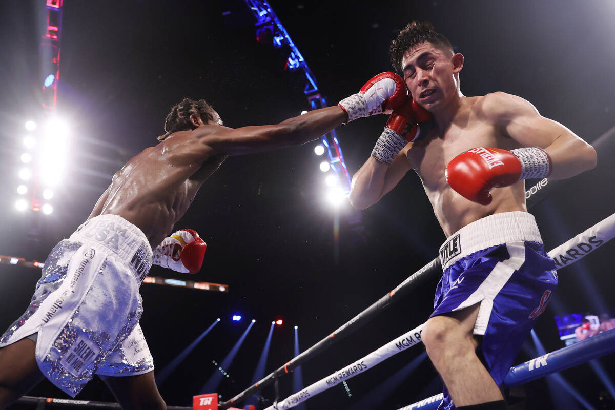 Keyshawn Davis, right, walks over Esteban Sanchez in the fifth round of a lightweight fight at ...