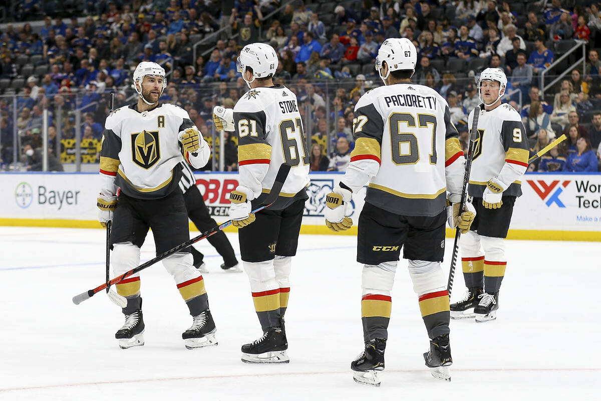 Vegas Golden Knights' Mark Stone (61) is congratulated by teammate Alex Pietrangelo (7) after s ...