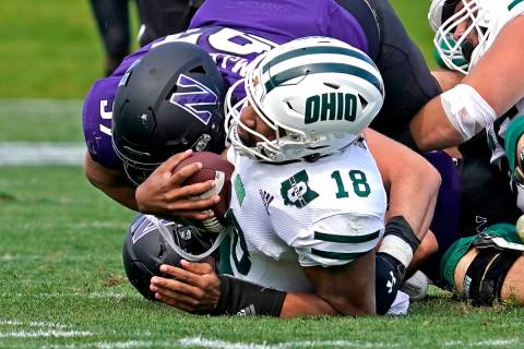 Ohio quarterback Armani Rogers (18) is sacked by Northwestern defensive lineman Sean McLaughlin ...