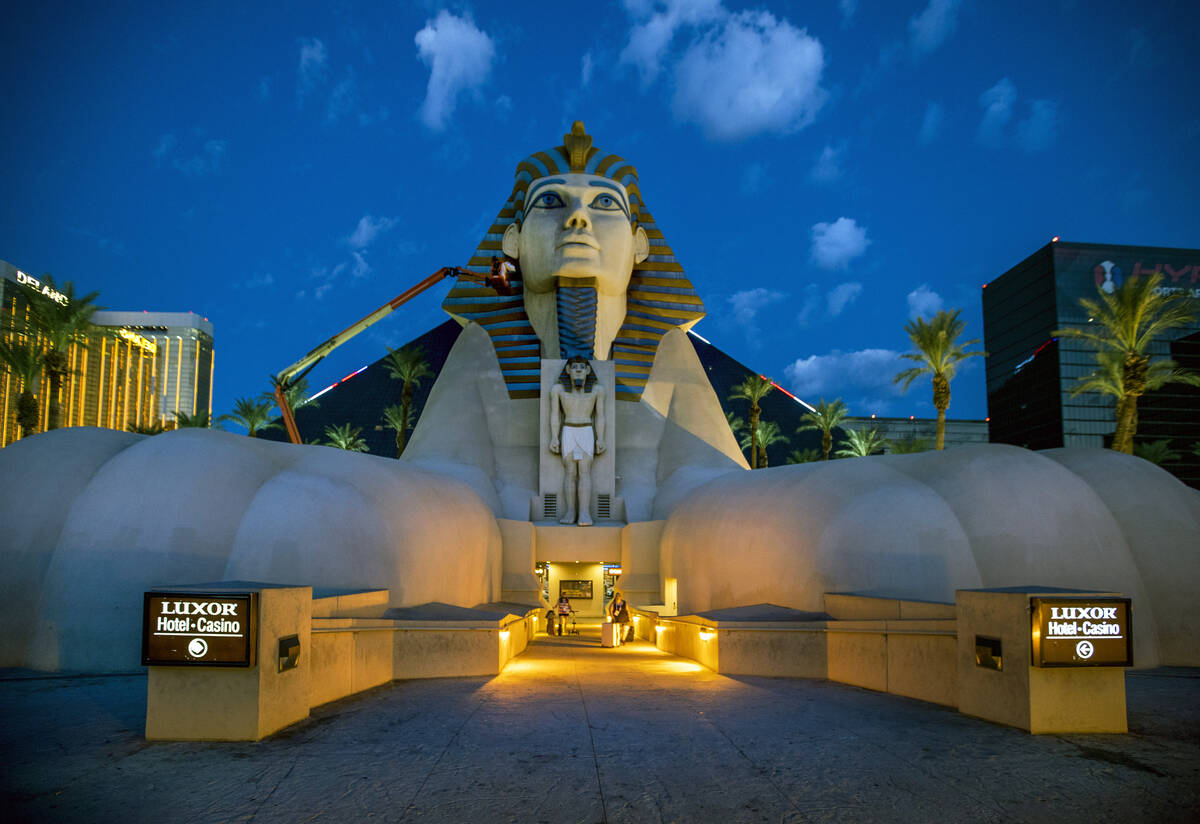 Access Solutions hangs a Raiders eye patch on the Great Sphinx of Giza replica outside of the L ...