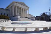People stand on the steps of the U.S. Supreme Court, Feb.11, 2022, in Washington. (AP Photo/Ma ...