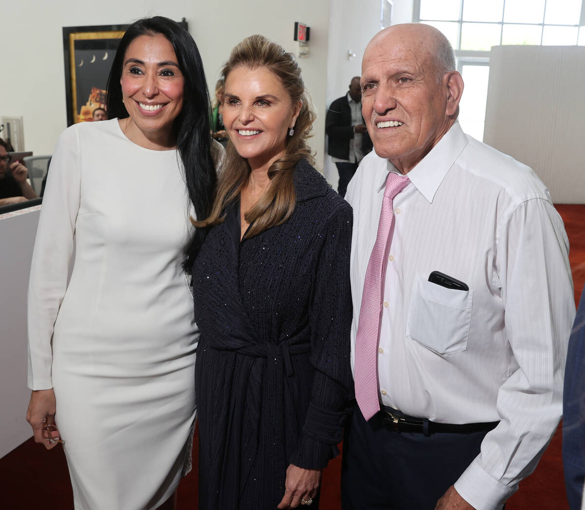 Maria Shriver, center, poses with Ivette Fernandez and her father Antonio Fernandez, both of La ...