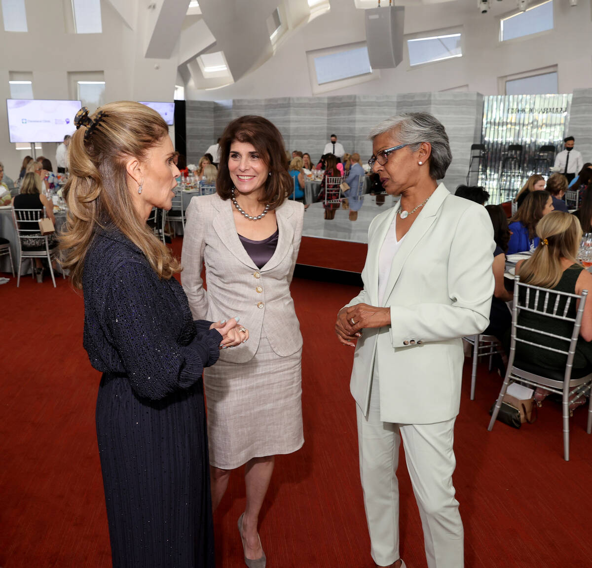 Maria Shriver, left, visits with Camille Ruvo, center, and Punam Mathur during a Mother's Day l ...