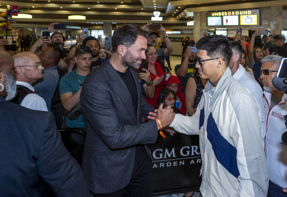 Matchroom Boxing Chairman Eddie Hearn, left, greets Dmitry Bivol during boxing Grand Arrivals a ...