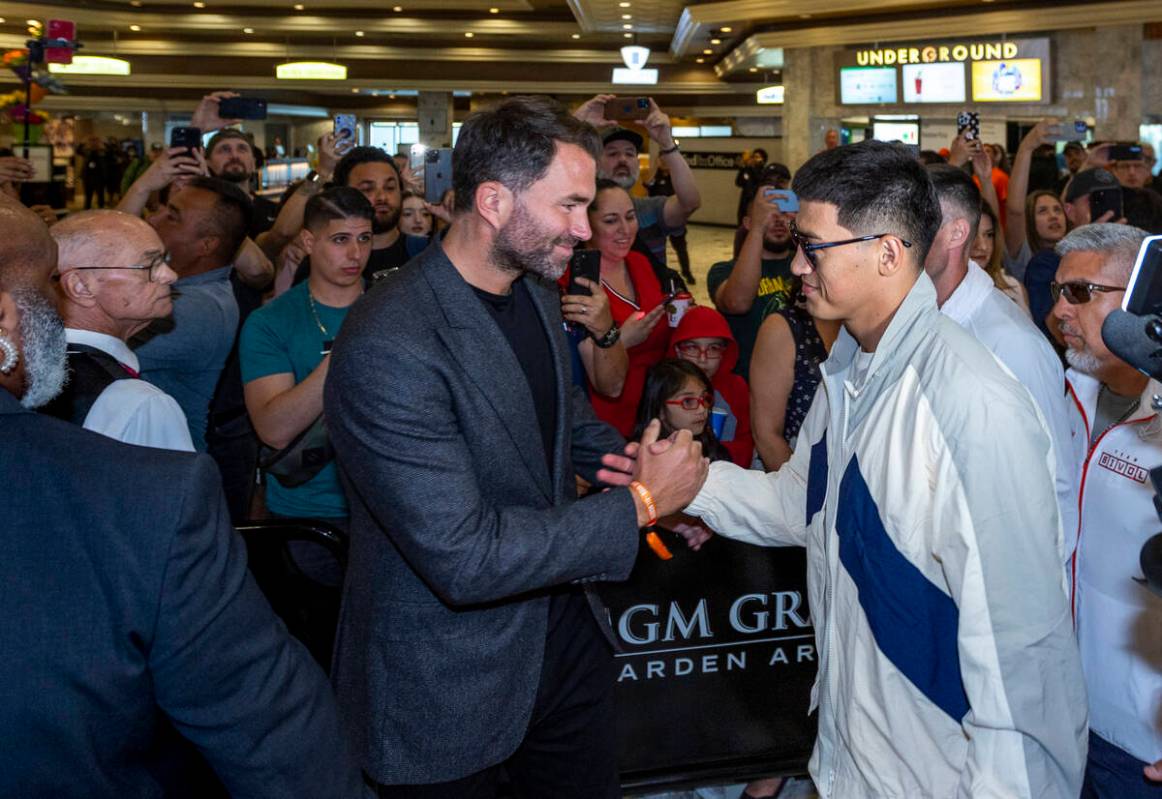 Matchroom Boxing Chairman Eddie Hearn, left, greets Dmitry Bivol during boxing Grand Arrivals a ...