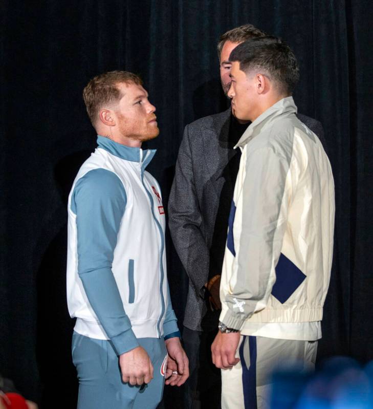 Canelo Alvarez, left, faces off with Dmitry Bivol, right, by Matchroom Boxing Chairman Eddie He ...