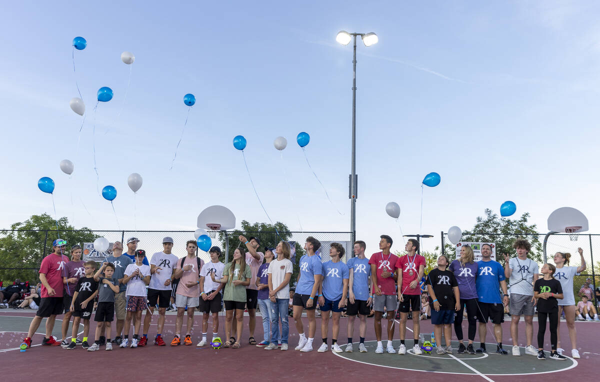 Family and friends release 16 balloons as part of a celebration of life for Austen Russell, 9, ...