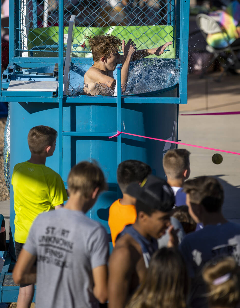 Oliver Lamar, 9, drops into the water while in a dunk tank as part of a celebration of life for ...