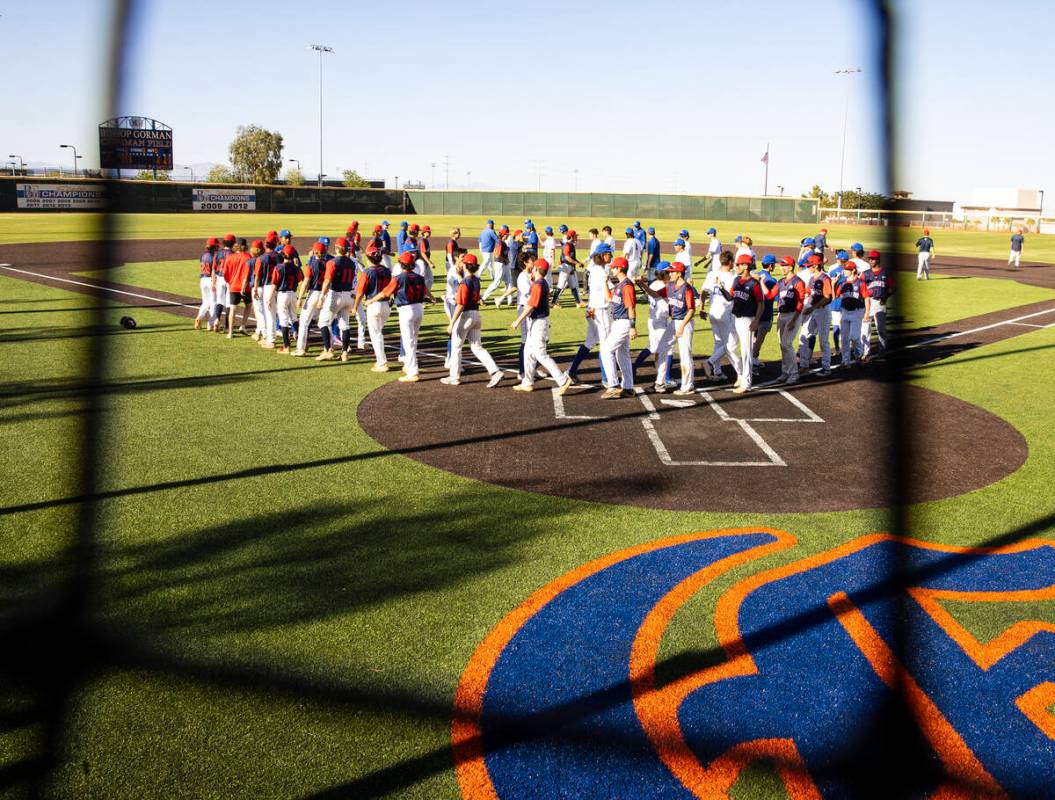 The Bishop Gorman and Coronado High baseball players shake hands after a playoff game at Bishop ...