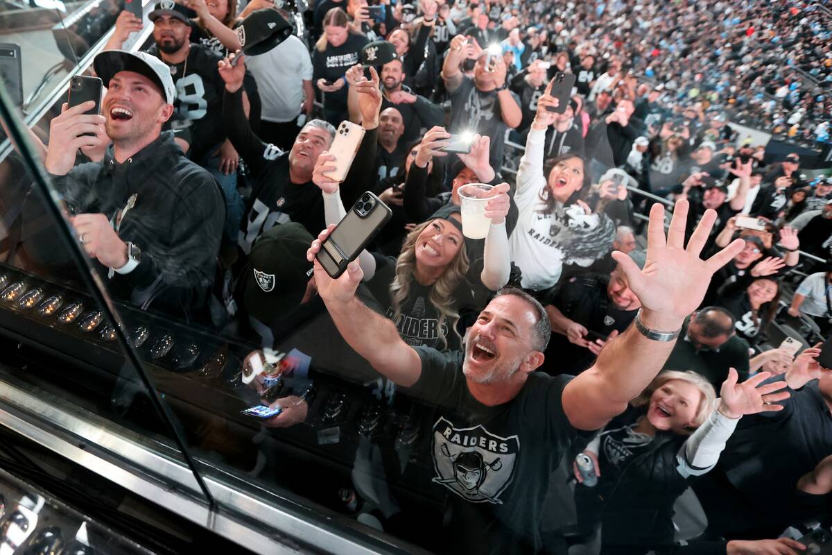 Fans cheer as Lil Jon performs with members of the Raiderettes during halftime as the Raiders t ...