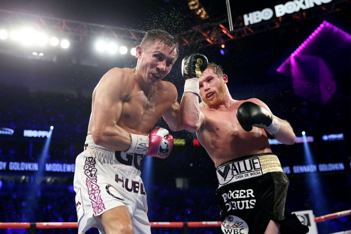 Saul "Canelo" Alvarez, right, connects a punch against Gennady Golovkin in the WBC, WBA, IBO, R ...