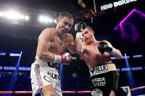 Saul "Canelo" Alvarez, right, connects a punch against Gennady Golovkin in the WBC, WBA, IBO, R ...