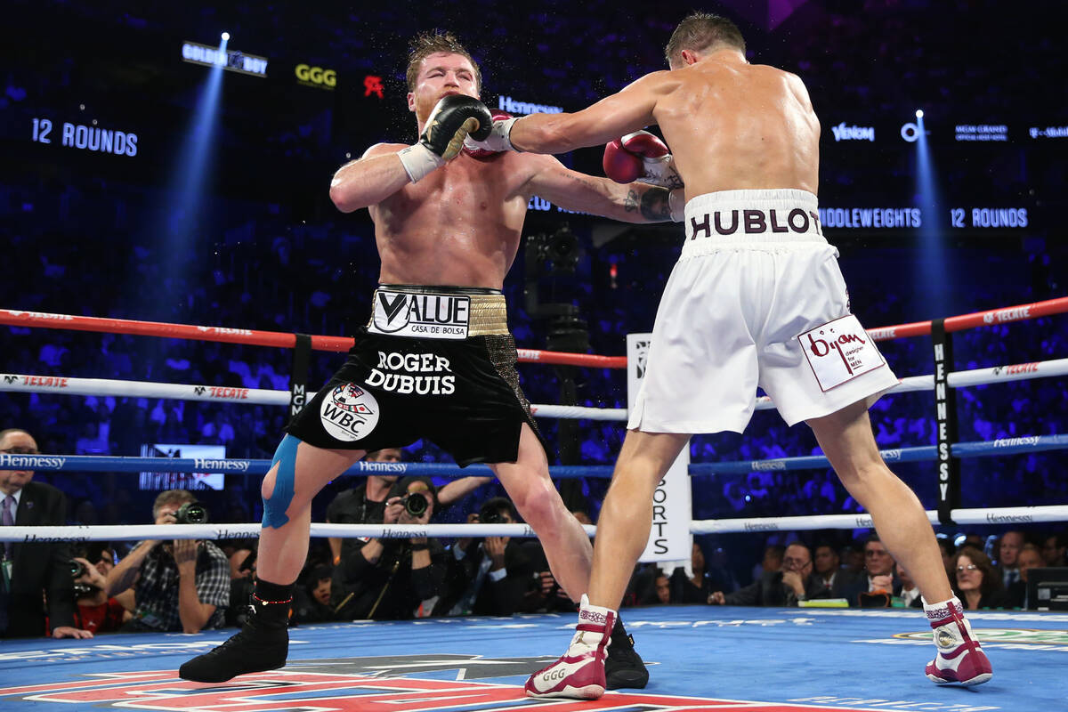 Gennady Golovkin, right, connects a punch against Saul "Canelo" Alvarez in the WBC, W ...