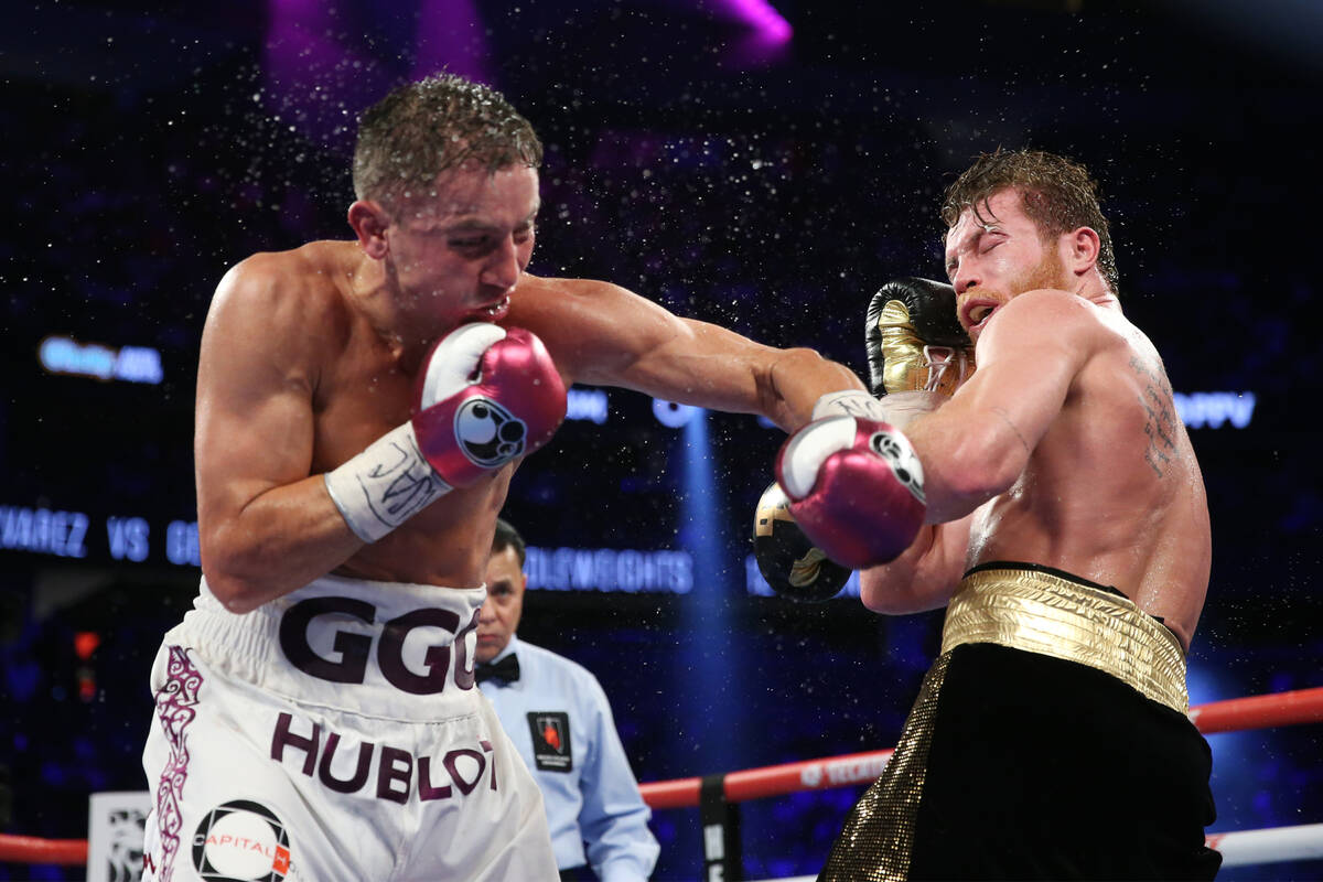 Gennady Golovkin, left, connects a punch against Saul "Canelo" Alvarez in the WBC, WB ...
