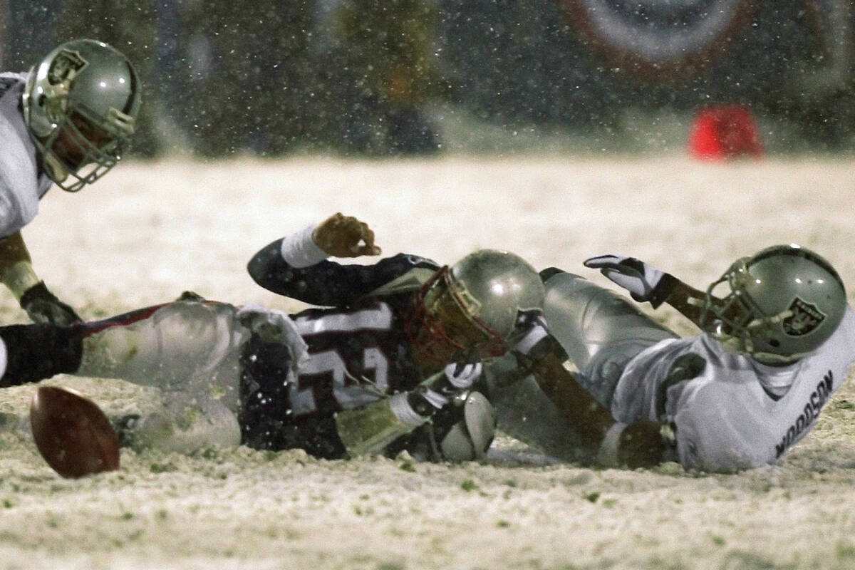 File-New England Patriots quarterback Tom Brady (12) loses the ball after being brought down by ...