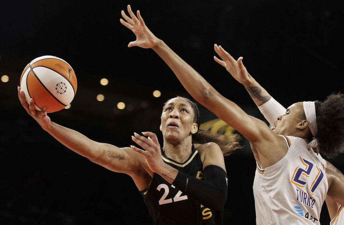 Las Vegas Aces forward A'ja Wilson (22) slices to the rim past Phoenix Mercury forward Brianna ...