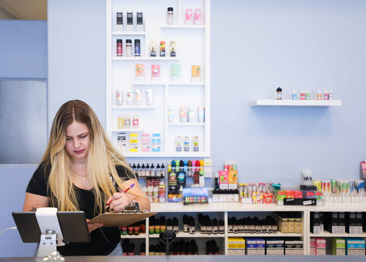 Marketing Manager Nicole Whelan works on inventory at Vapeco in Las Vegas, Thursday, May 12, 20 ...