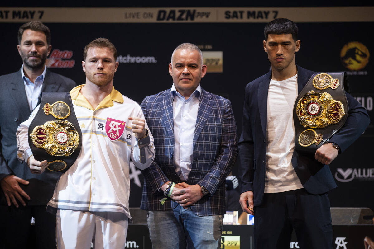 Saul “Canelo” Alvarez, left, and Dmitry Bivol, right, pose with World Boxing Asso ...