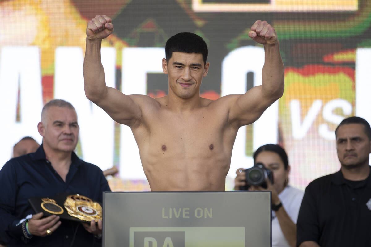 Dmitry Bivol stands on a scale during a ceremonial weigh-in event at Toshiba Plaza in Las Vegas ...