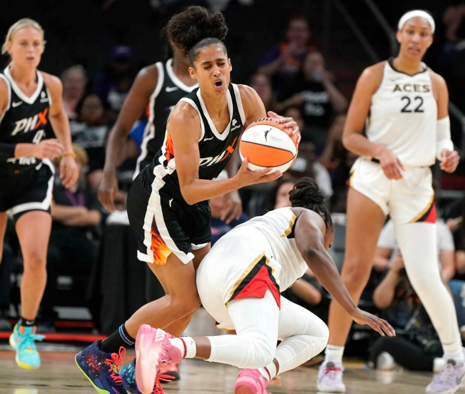 Phoenix Mercury's Skyer Diggins-Smith (4) gets bumped at the knees by Las Vegas Aces' Chelsea G ...