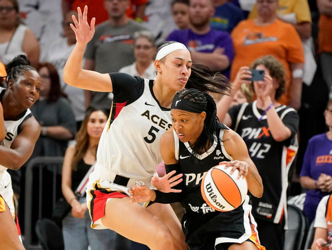 Phoenix Mercury's Shey Peddy, front right, drives around Las Vegas Aces' Dearica Hamby (5) duri ...