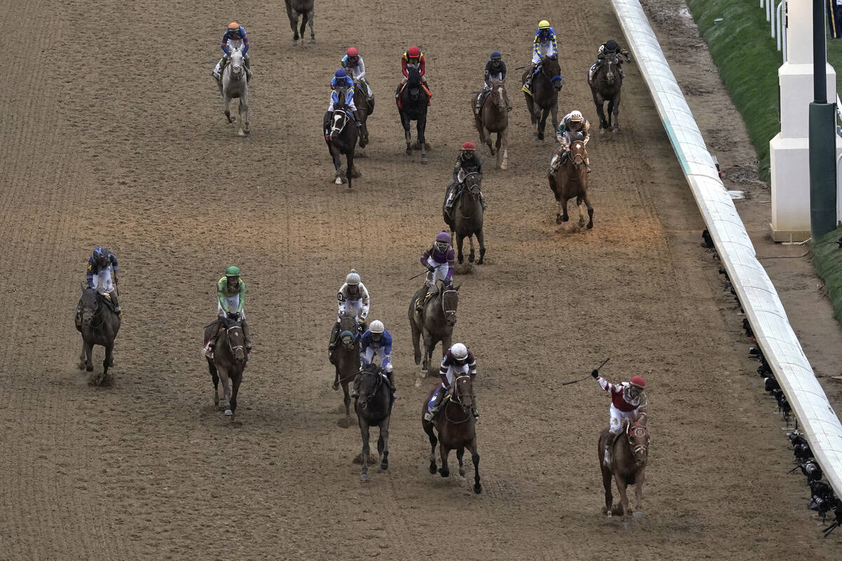 Jockey Sonny Leon celebrates after riding Rich Strike, lower right, to victory in the 148th run ...