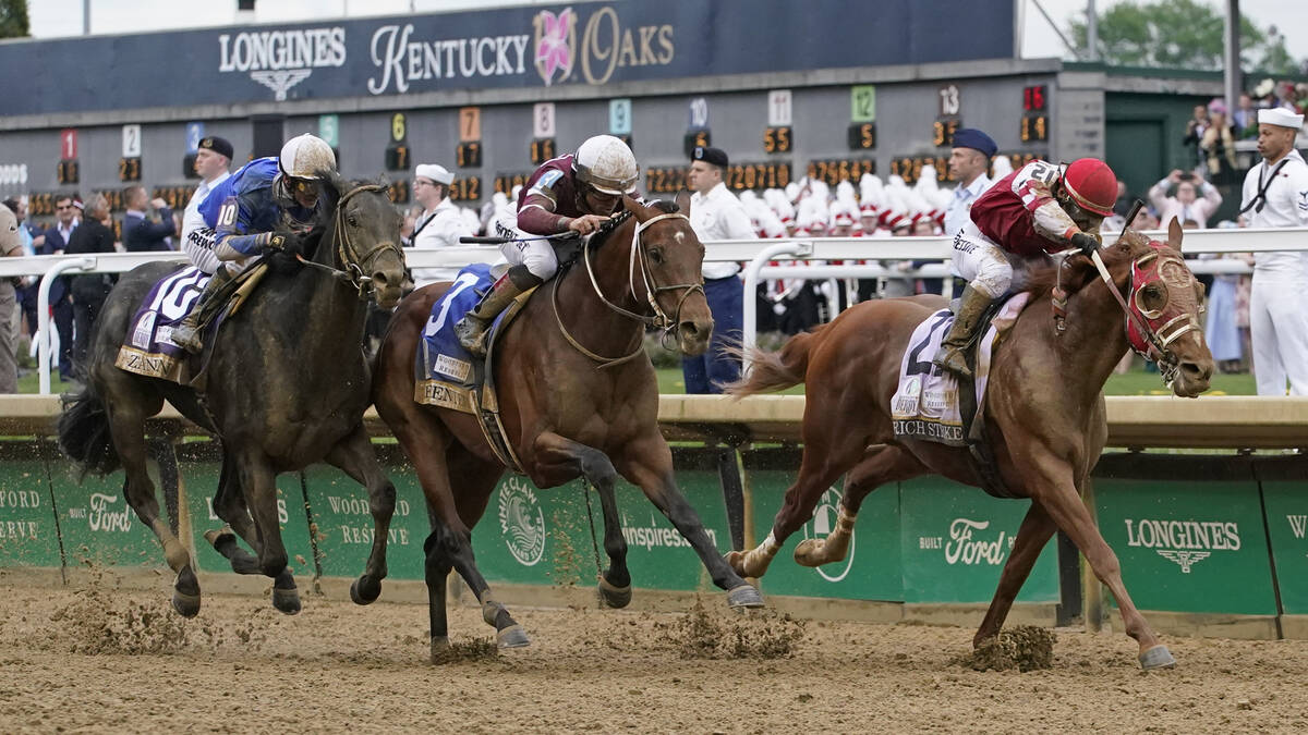 Rich Strike (21), with Sonny Leon aboard, leads Epicenter (3), with Joel Rosario aboard, and Za ...