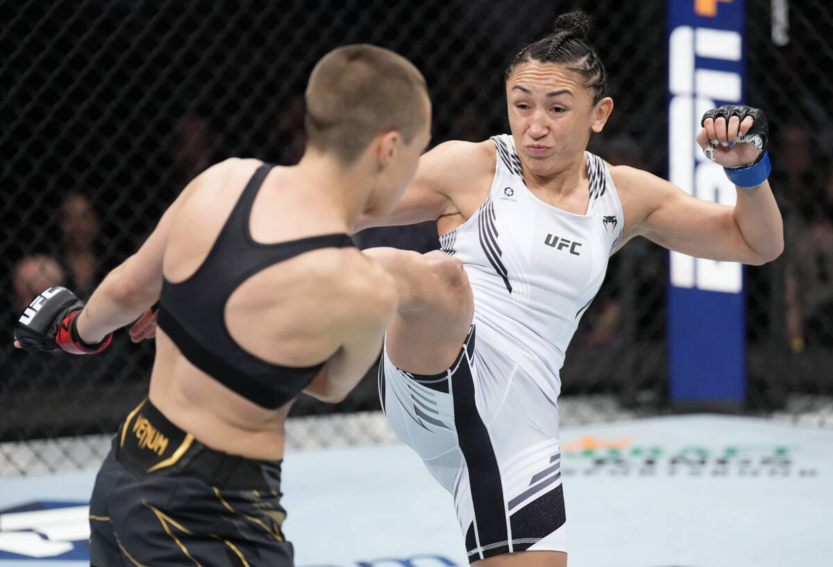 Carla Esparza kicks Rose Namajunas in the UFC strawweight championship fight during the UFC 274 ...