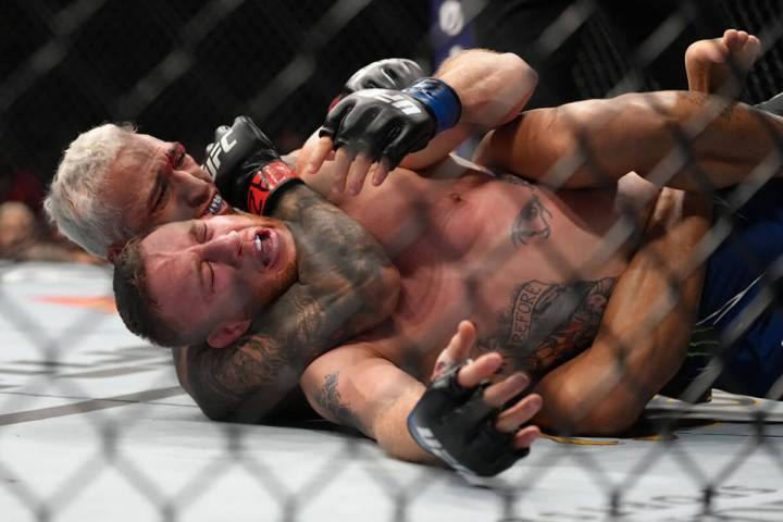 Charles Oliveira of Brazil secures a rear choke submission against Justin Gaethje in the UFC li ...