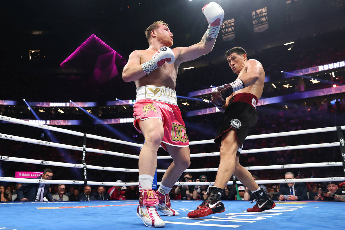 Saul “Canelo” Alvarez, left, throws a punch against Dmitry Bivol in the second round of the ...