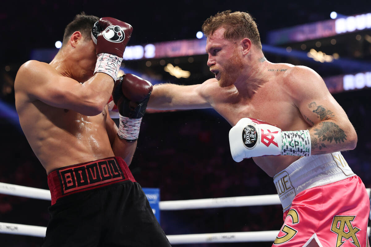 Saul “Canelo” Alvarez, right, throws a punch against Dmitry Bivol in the second round of th ...