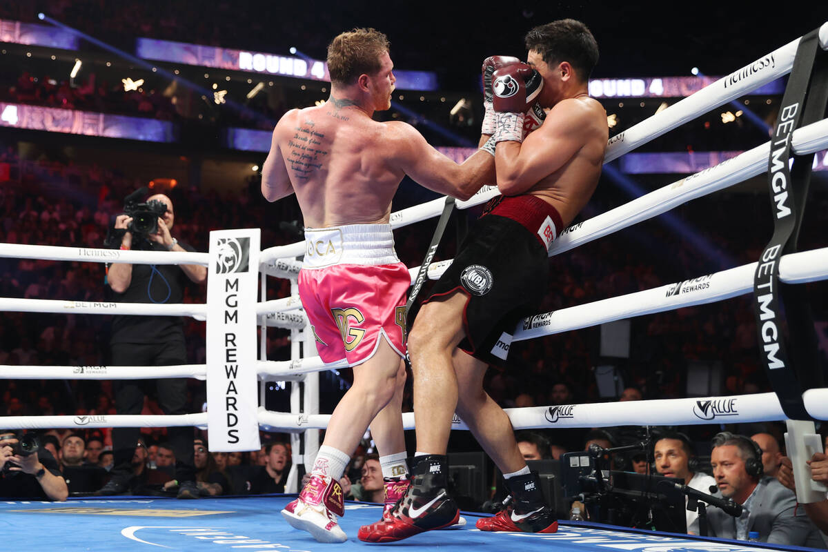 Saul “Canelo” Alvarez, left, connects a punch against Dmitry Bivol in the fourth ...