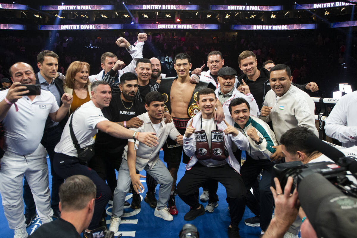 Dmitry Bivol poses with his team after his unanimous decision win against Saul “Canelo&# ...