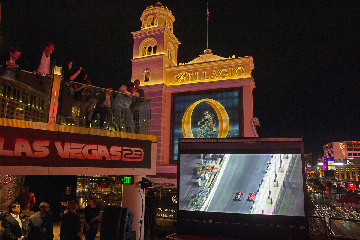 In this March 30, 2022, file photo, people watch a screen on the Las Vegas Strip during a news ...