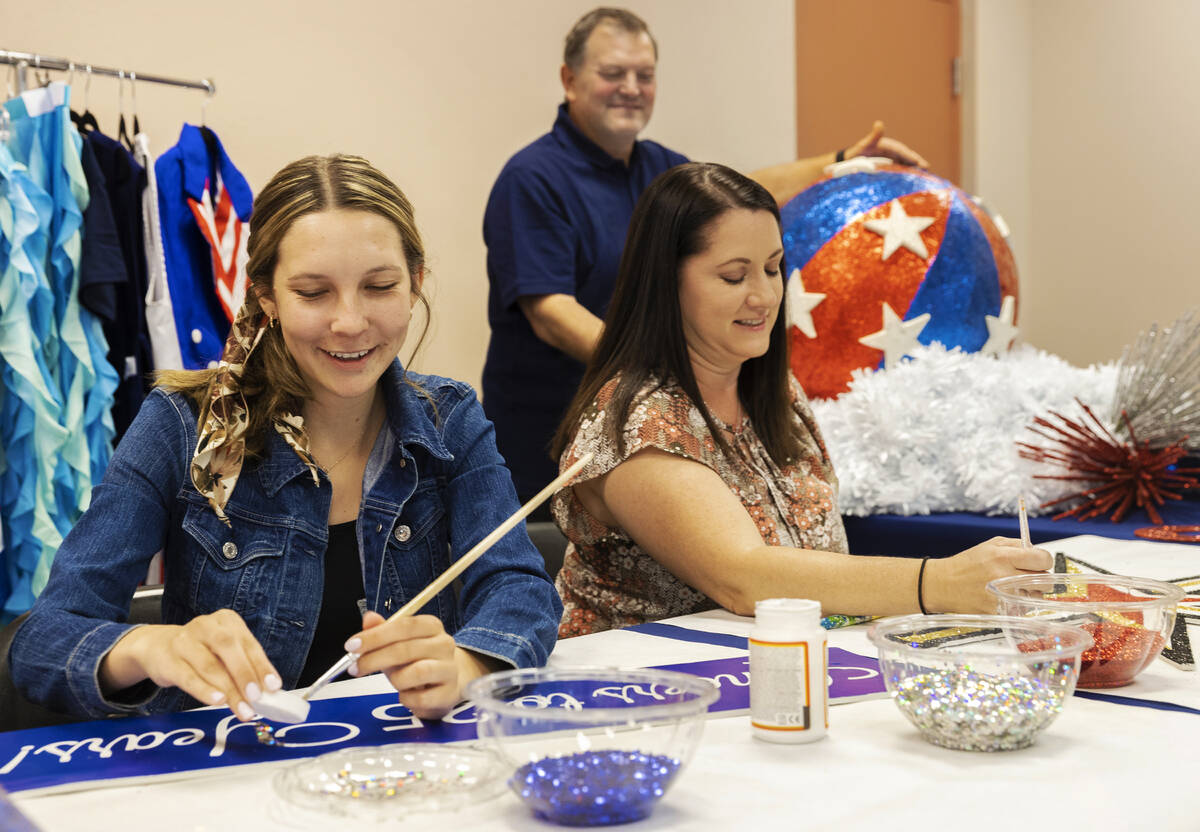 Danielle Cox, left, Shannon Cavasar and Tommy Porrello prepare for the July Fourth parade at T ...