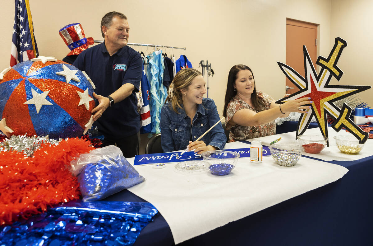 Tommy Porrello, left, Danielle Cox and Shannon Cavasar prepare for the July Fourth parade at Tr ...