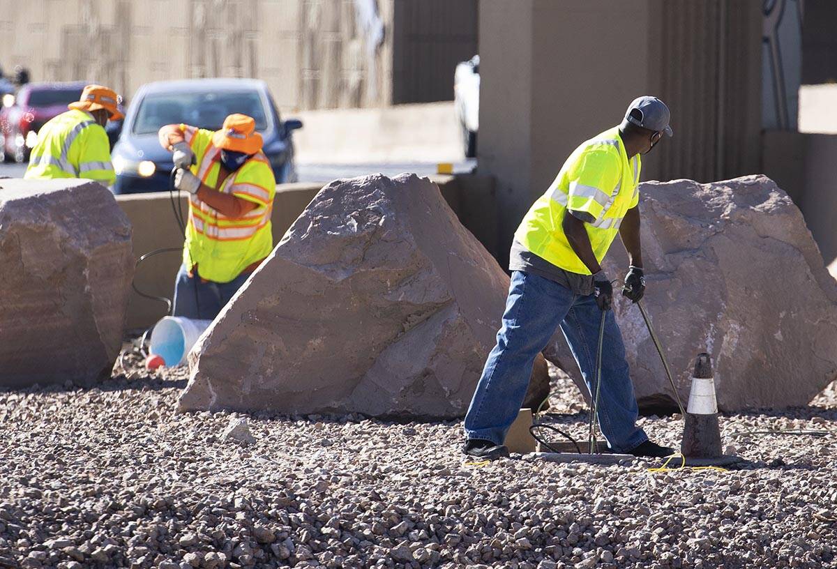 NDOT workers replace copper wire after Spaghetti Bowl lights were knocked out by copper wire th ...