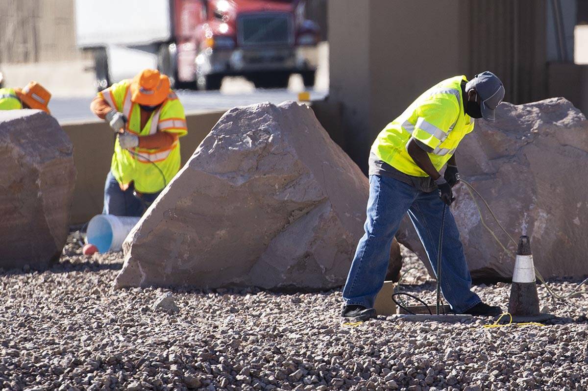 NDOT workers replace copper wire after Spaghetti Bowl lights were knocked out by copper wire th ...