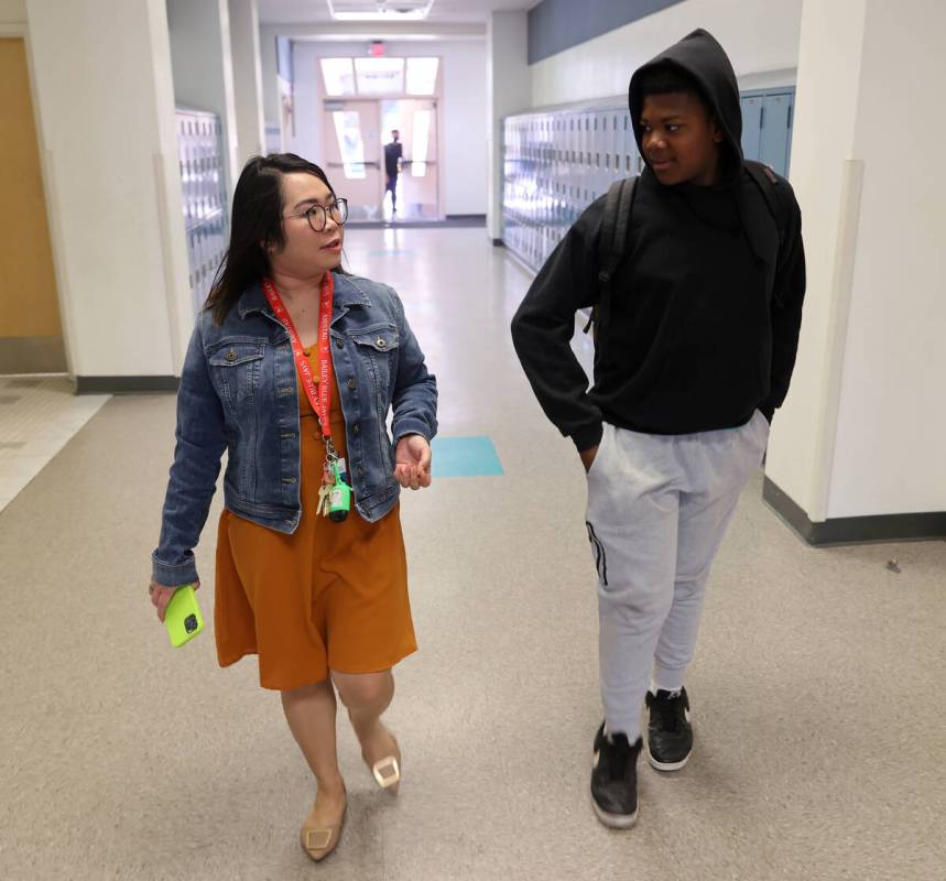 Bailey Middle School teacher Nina Karen Napoles talks with her student Dajuan Dunn, 12, at the ...