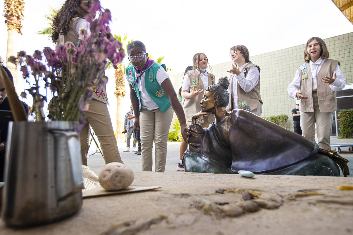 Aliyah, 10, of Girl Scout Troop 294, looks at the statue “In Grace” which had been stolen f ...