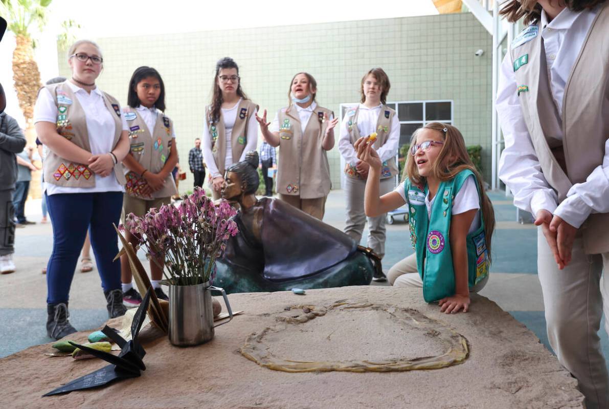 MarrissaAnn of Girl Scout Troop 601, holds up a piece of adhesive from where the statue &#x201c ...