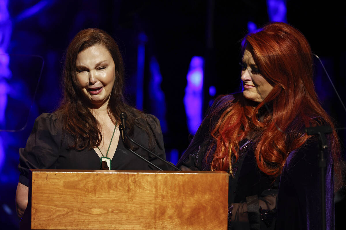 Ashley Judd, left, cries as she speaks while sister Wynonna Judd listens during the Country Mus ...