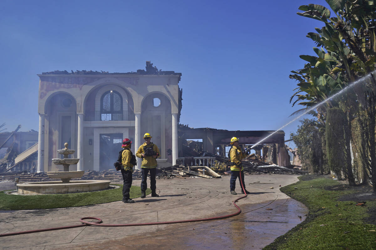 Members of the Torrance Fire Dept, from left, Brent Nunez, Michael Cotter and Rick Cathey prote ...